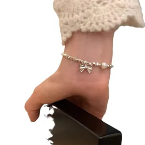 Elegant S925 sterling silver bracelet featuring a delicate bow charm and irregular pearl