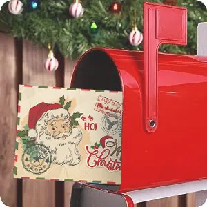 Vintage Christmas greeting card with Santa Claus design inside a festive red mailbox