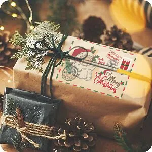 Vintage Kraft Christmas card label featuring a Santa Claus design on a gift box