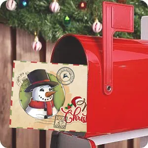 Close-up of a vintage Christmas card with a cute snowman design in a red mailbox.