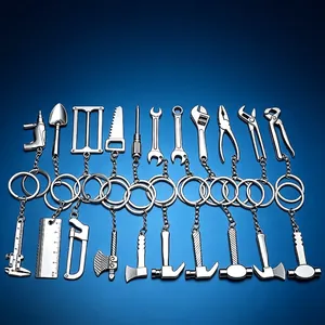 Miniature metal tool keychain set featuring wrench hammer axe and caliper shapes