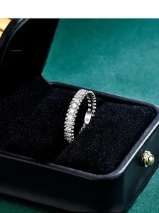 Close-up of S925 sterling silver moissanite eternity ring with beaded edge in jewelry box