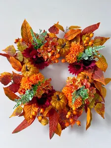 Detailed top view of an autumn harvest wreath with pumpkins berries and hydrangea flowers