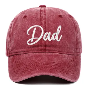 Detailed close-up of a vintage red washed cotton baseball cap with white Dad embroidery