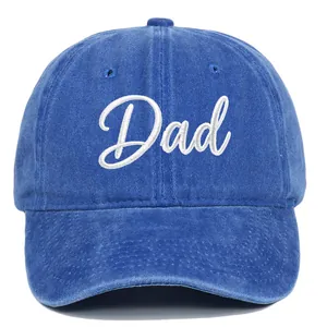 Detailed macro view of white 'Dad' embroidery on a vintage blue washed baseball cap.