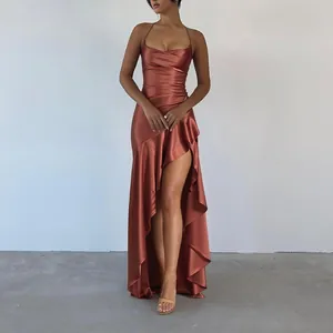 Close-up detail of copper satin slip dress featuring high-low ruffled hem and high slit