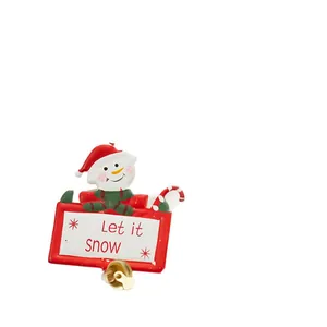 Christmas metal snowman hanging ornament featuring Let it Snow sign and golden bell.