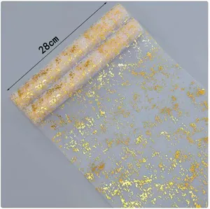 Close-up of 28cm wide white mesh table runner with irregular gold foil pattern