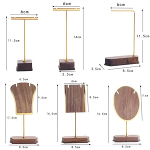 Multiple solid wood and gold metal jewelry display stands for earrings and necklaces
