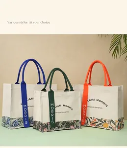 William Morris style canvas tote bags with colorful ribbons and artistic floral prints.