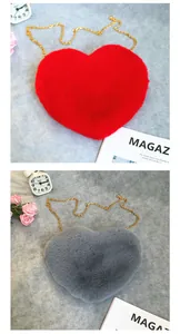 Detailed macro view of heart-shaped plush crossbody bags in vibrant red and grey colors