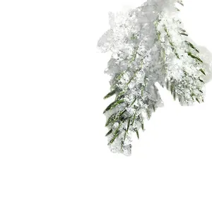 Realistic artificial dry snow powder on a pine branch for festive Christmas decor.