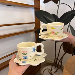 Handcrafted ceramic flower coffee cup and saucer set with unique heart handle