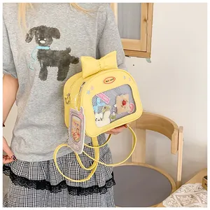 Macro detail of yellow PU leather ita bag with cute bow and clear PVC display window