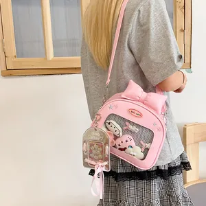 Pink Ita Bag cross-body backpack with clear window, decorative bow and adjustable strap