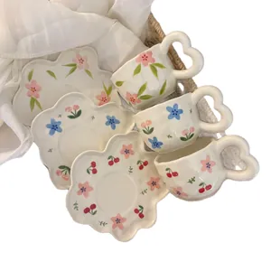 Floral ceramic coffee cup set with heart handle and petal saucer in wicker basket