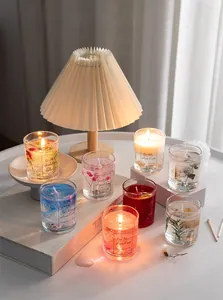 Macro shot of assorted colorful jelly scented candles with dried flowers and conch shells