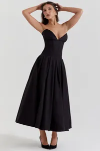 Detail of sexy black corset dress with sweetheart neckline and pleated midi skirt