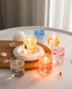 Macro detail of gel wax scented candles with dried flowers and gold flakes in glass