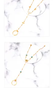 Detailed view of gold plated hand chain bracelets with heart and tree of life motifs