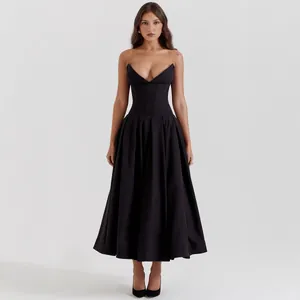 Close-up of elegant black corset dress with deep V-neckline and voluminous pleated skirt