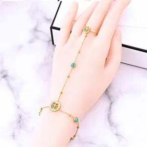 Gold-plated ring-bracelet combo with tree of life charm and turquoise beads on hand