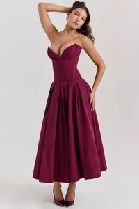 Detail of the deep wine red corset dress featuring a V-neckline and full pleated skirt