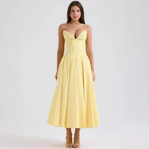 Close-up of a pale yellow corset dress featuring a deep V-neckline and structured boning