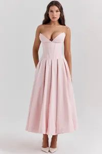 Detail of light pink corset waist dress with structured vertical seams and V-neckline