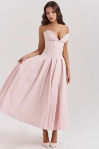 Detail view of the elegant pink corset bodice and pleated A-line skirt of the dress