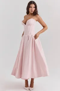 Detail of light pink corset-style evening dress with V-neckline and pleated A-line skirt