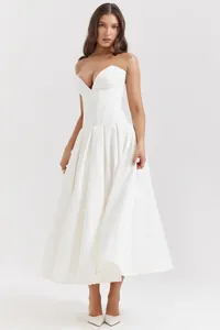 Detail of white midi dress with deep V-neck corset bodice and elegant flared skirt