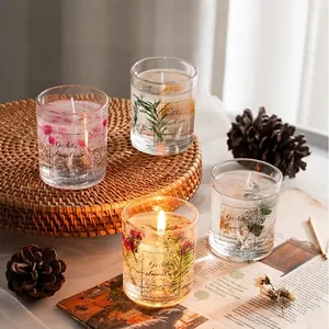 Exquisite gift box of four clear jelly candles with dried flowers in glass jars