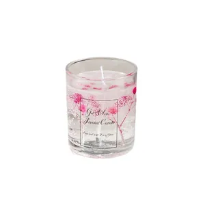 Exquisite gel wax scented candle with pink dried flowers in a clear glass cup