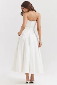 Detailed view of white corset dress with structured boning and back zipper closure
