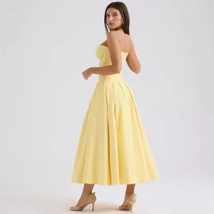 Elegant pale yellow strapless midi dress with boned bodice and pleated flared skirt