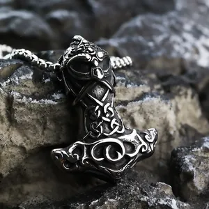Detailed macro shot of vintage Viking Mjolnir pendant with Celtic knots on dark rock