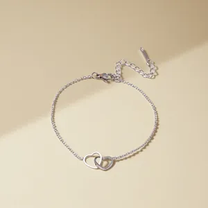 Elegant silver interlocking double heart bracelet with delicate chain for women