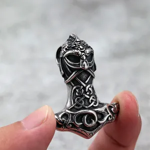 Nordic Viking Mjolnir pendant in vintage stainless steel held by hand to show scale