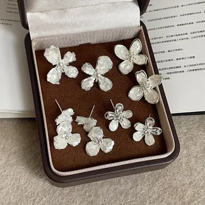 Elegant French flower stud earrings with shell petals and pearls in jewelry box