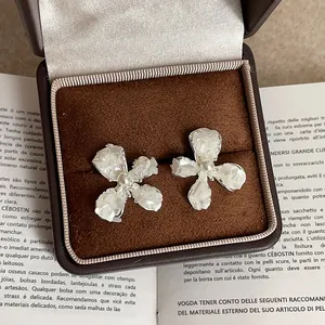 Detail of shell flower stud earrings with pearl center in a vintage velvet box