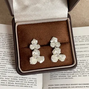 Close-up of shell flower earrings with pearl finish in a premium jewelry box