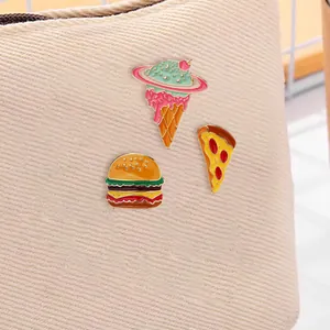 Enamel pins set featuring creative burger pizza and planet ice cream designs on bag