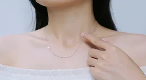 Detailed close-up of a minimalist S925 sterling silver O-chain necklace on a model's neck