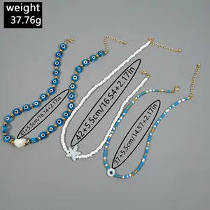 Detailed macro view of layered beaded beach necklaces with starfish and evil eye charms