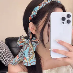 Vintage blue floral ribbon headband with a large bow for an elegant hair styling look