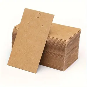 Detailed view of stacked brown kraft paper earring display cards for small business