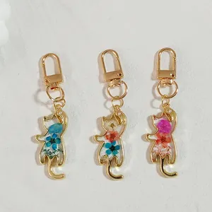 Set of cat-shaped resin keychains featuring colorful natural dried flowers in pastoral style