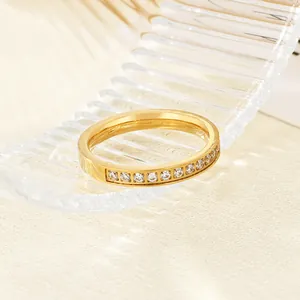 Close-up of a minimalist gold-plated stainless steel ring featuring zircon stone inlay