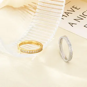 Close-up detail of gold and silver stainless steel rings set with sparkling clear zircons